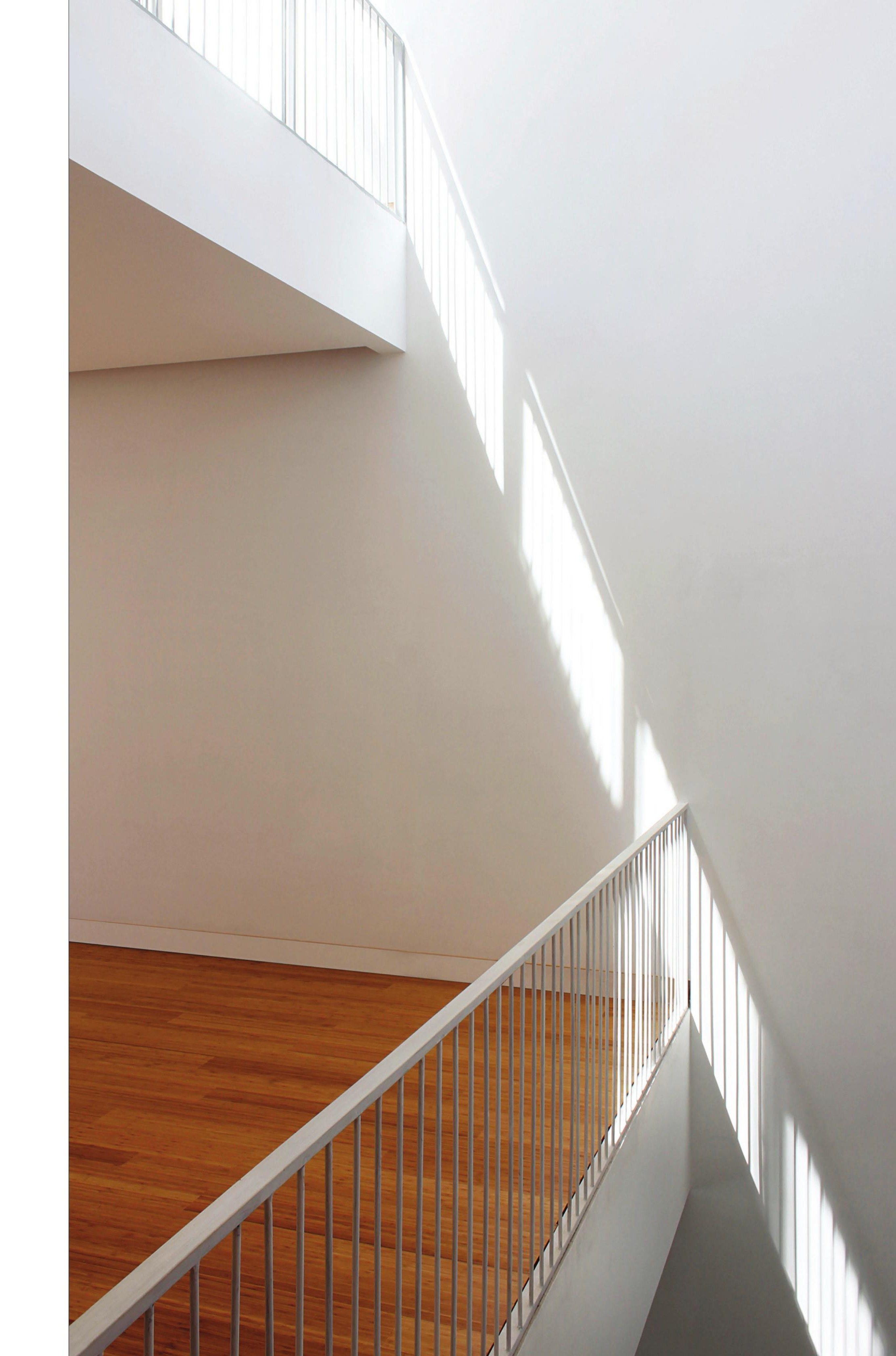 Cantilevered stair landing under the central void.