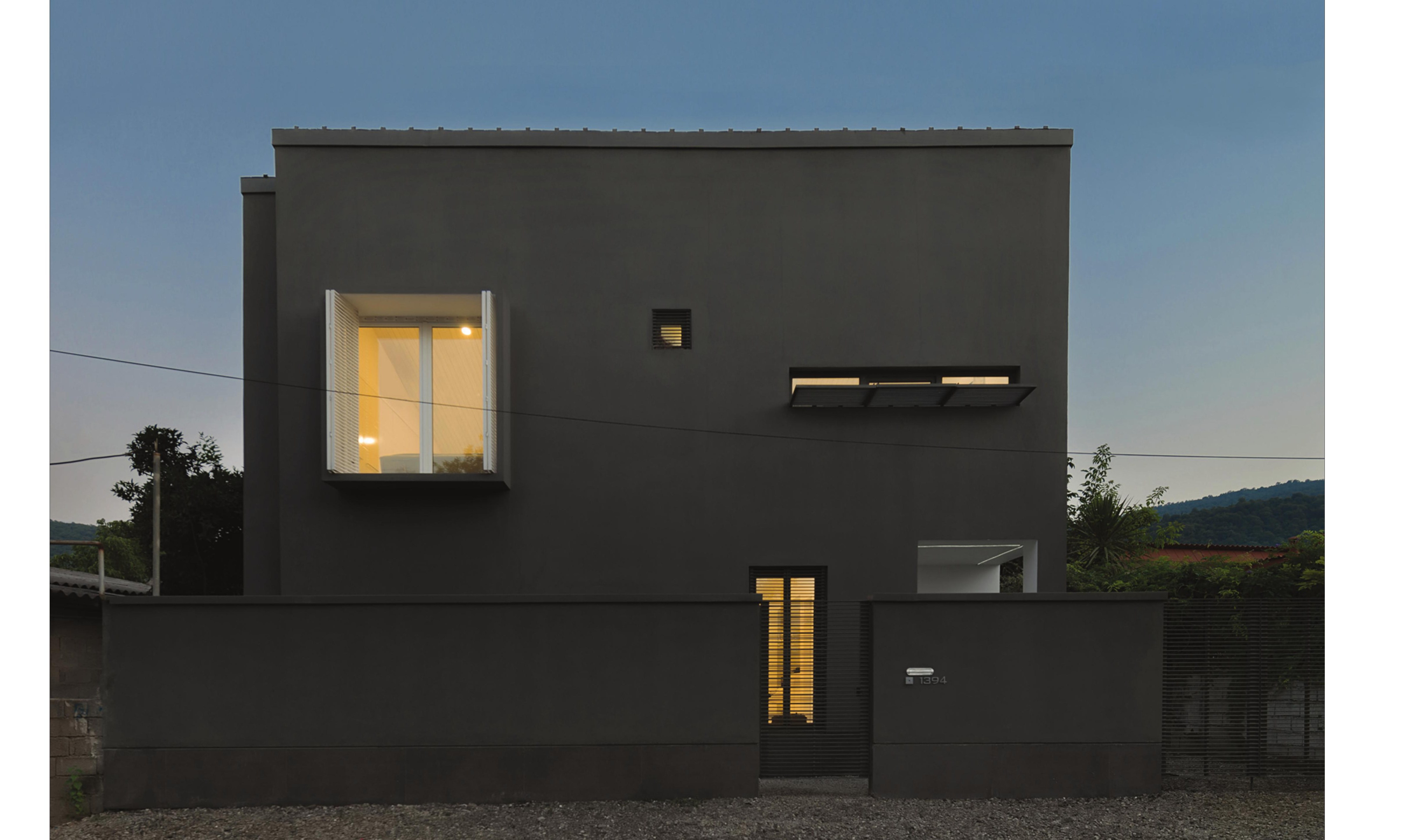 Evening view of the long south facade with its punctuated openings.