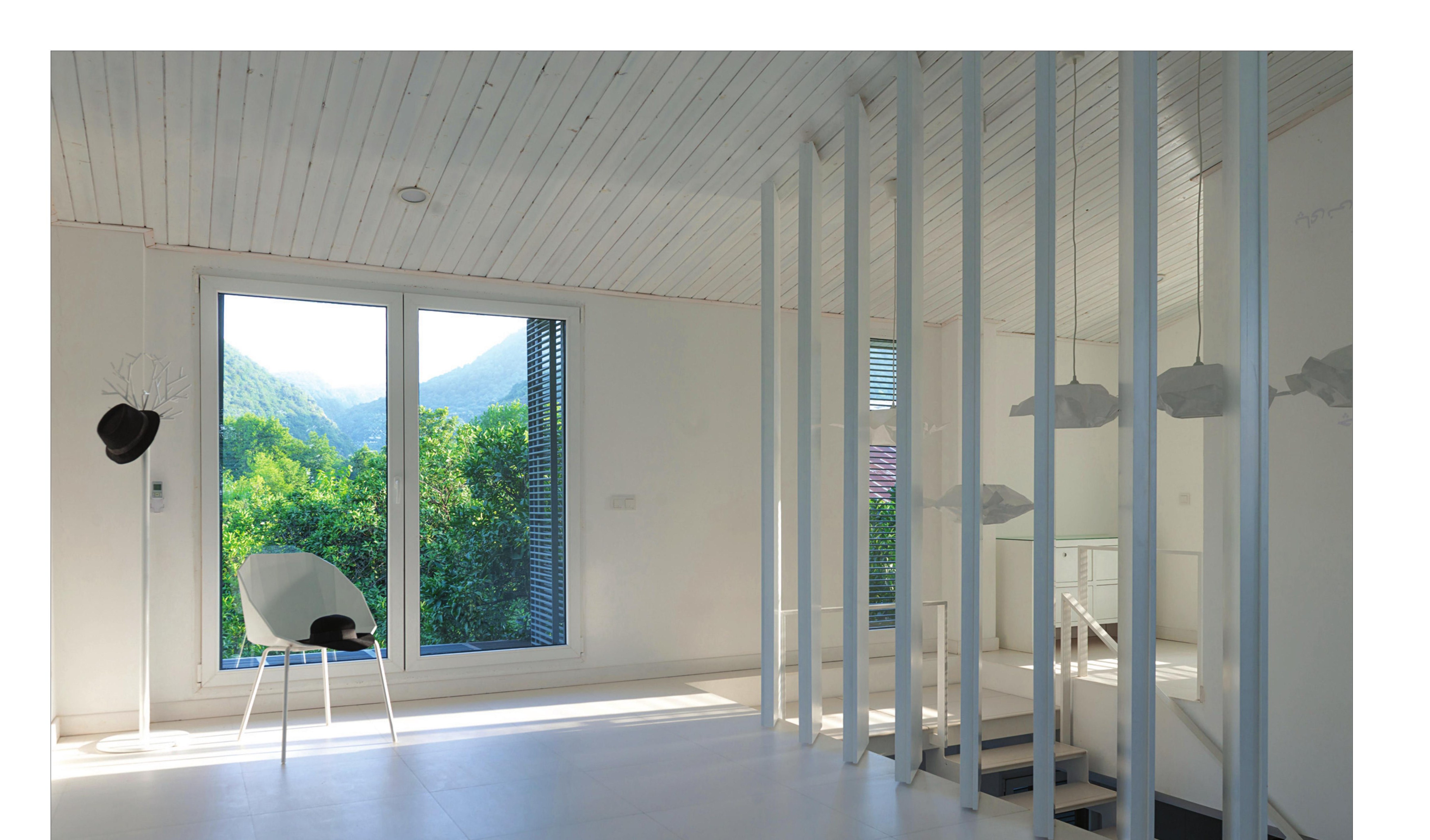 Living room with the white skylight, view to the Caspian foothills and the white slatted screen.