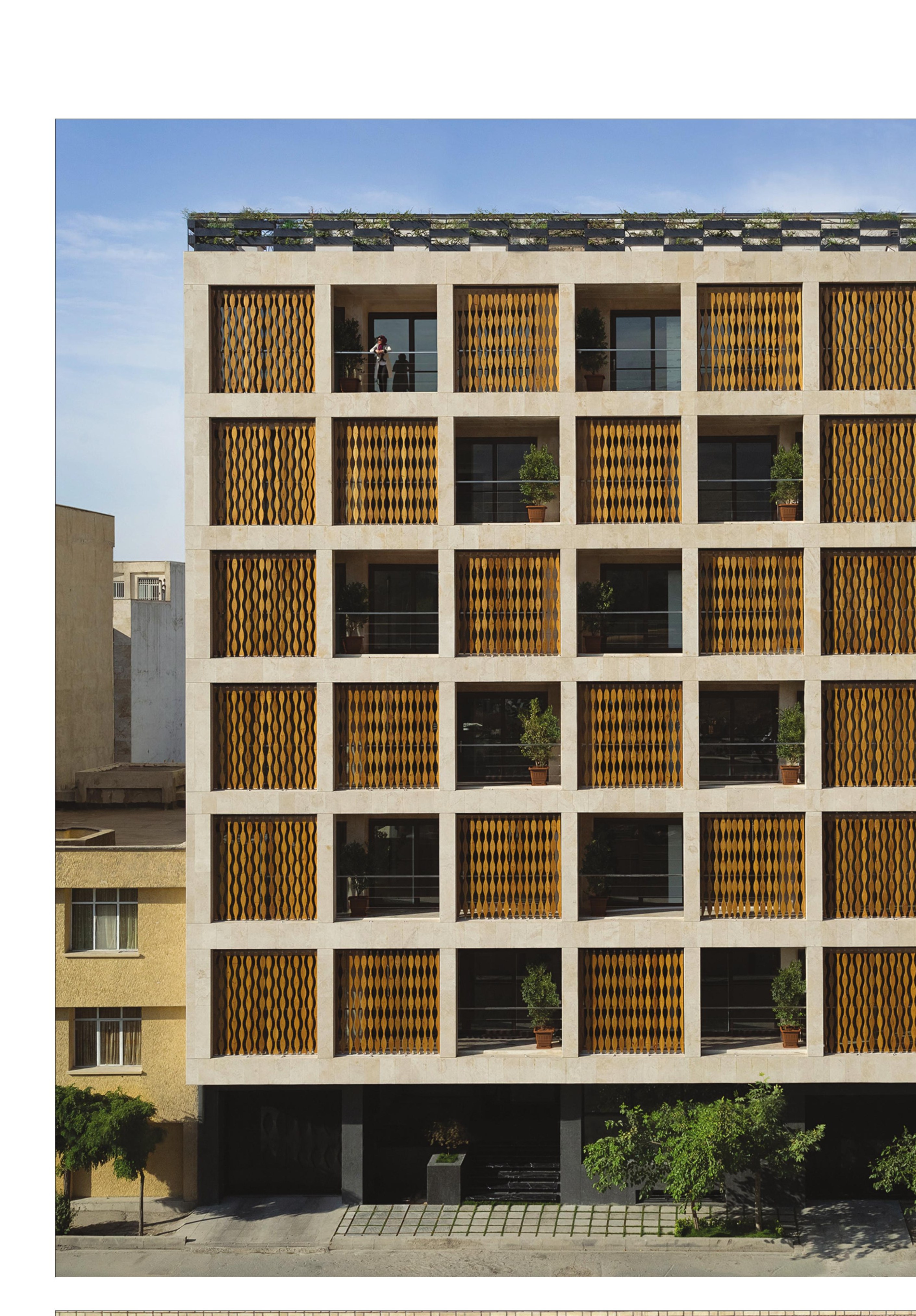 Full elevation: the changeable wooden second skin against the rigid masonry frame.