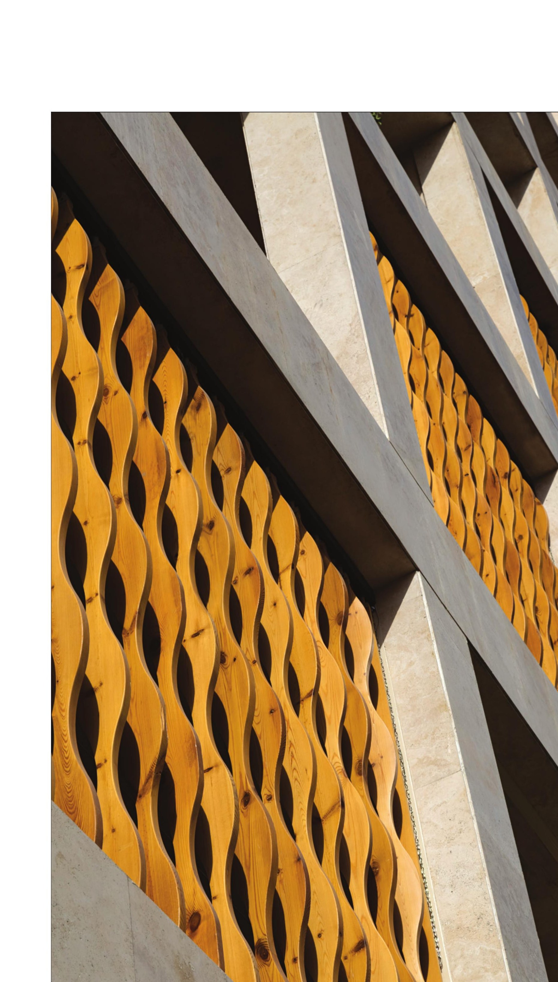 Detail of the timber rain-screen running over the masonry mullions.