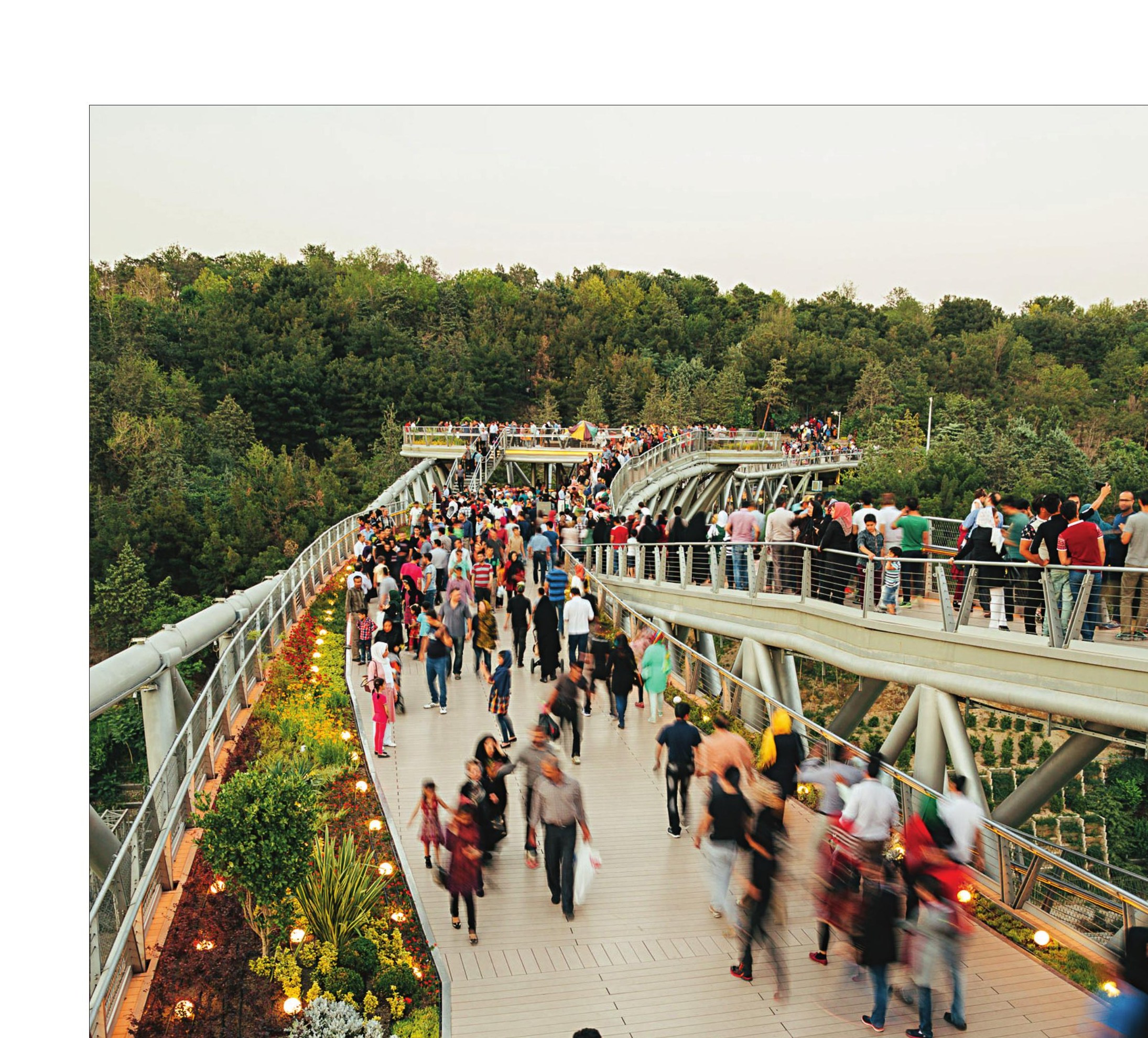 Visitors on the upper deck enjoying the bridge as a destination, not a passage.