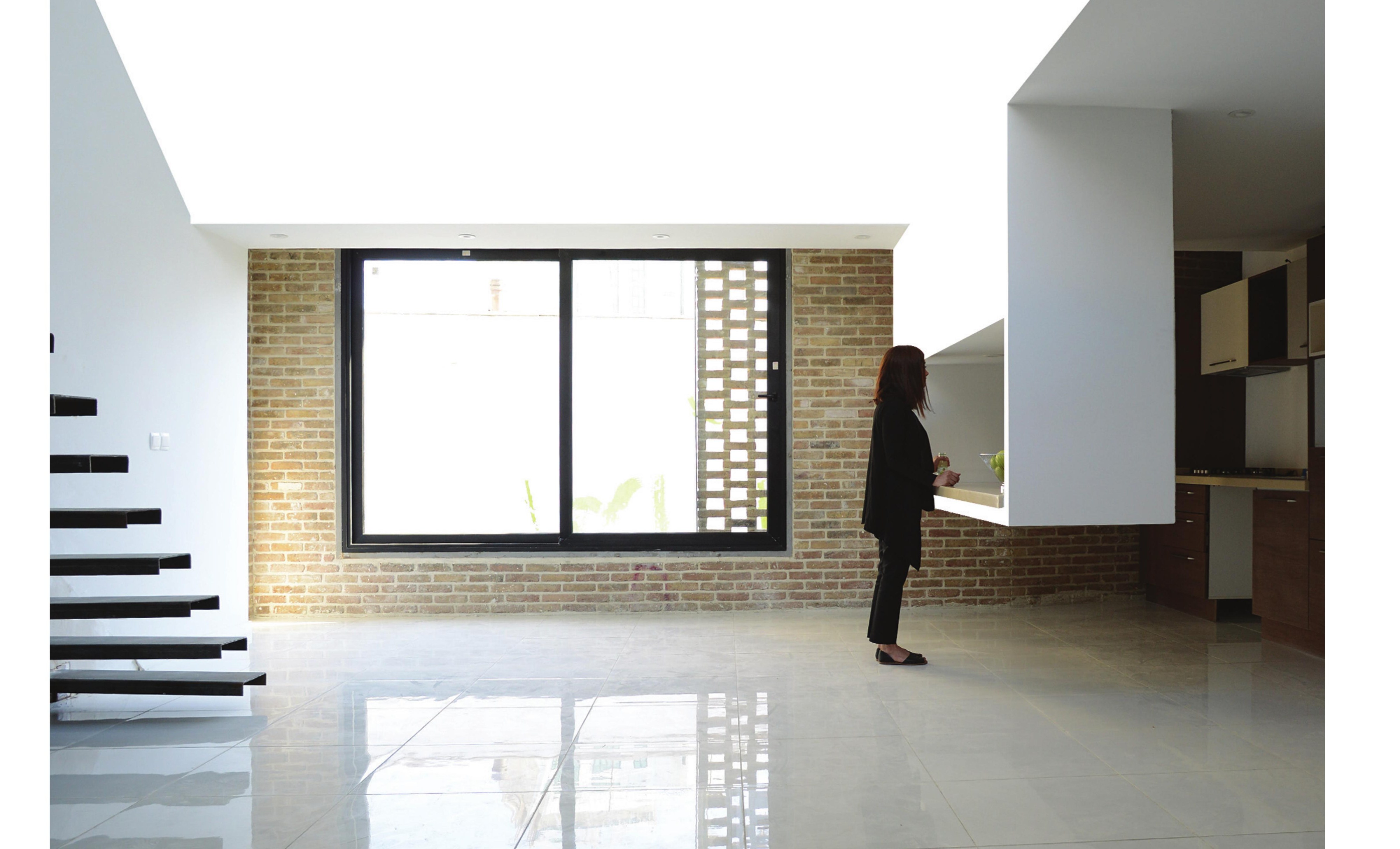 Living room: salvaged brick brought inside as a finished interior surface.