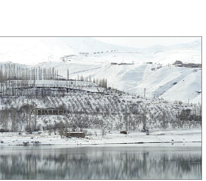 Taleghan Dam reservoir in winter, southern ridge of Alborz in the distance