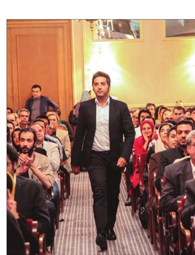 Amir Hossein Tabrizi walking down the audience aisle to the stage