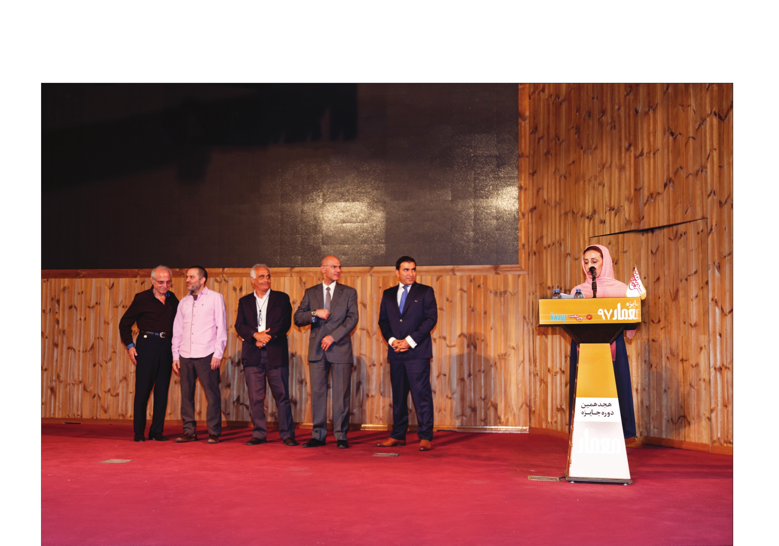 Award stage — winners and sponsors with the host