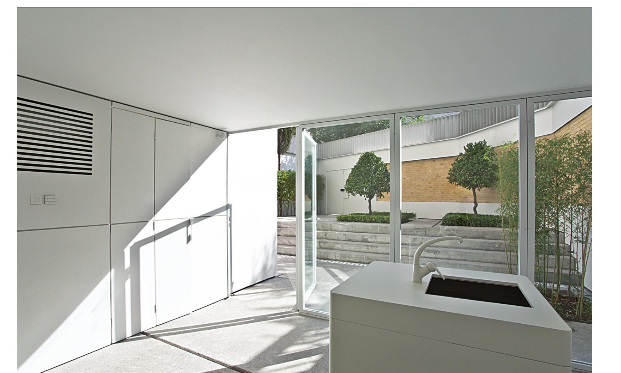 Gallery interior with concrete sink island opening onto the new courtyard
