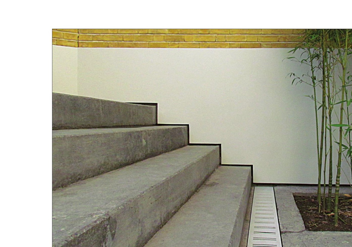 Bamboo bed beside the stepped concrete platforms of the new courtyard