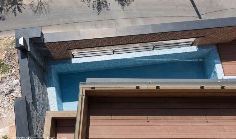 Top-down view of the swimming pool set into the brick courtyard