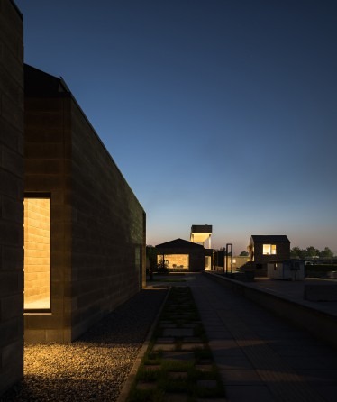 Concrete-block volume against the field edge