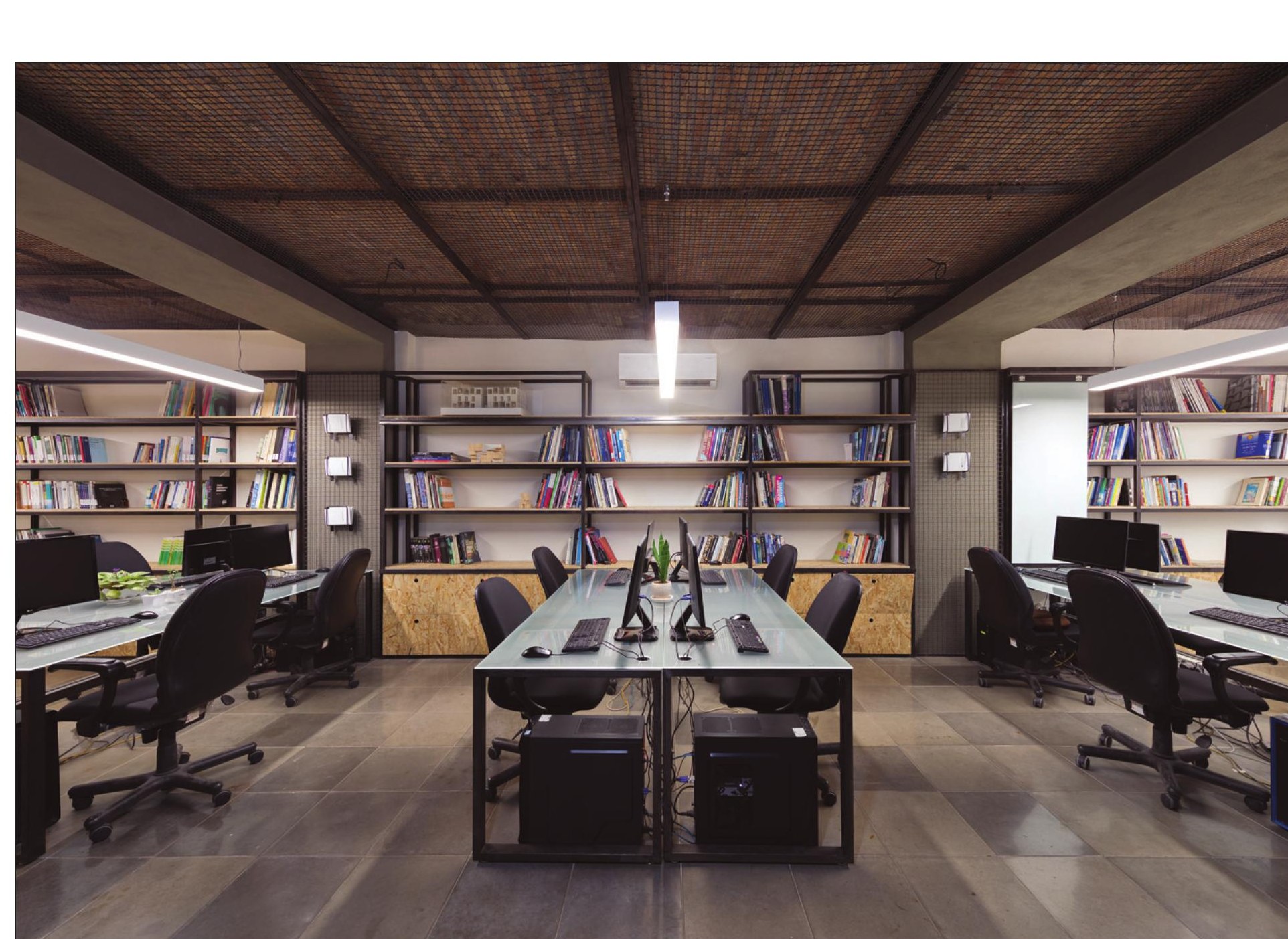 Atelier and library under exposed brick vaults