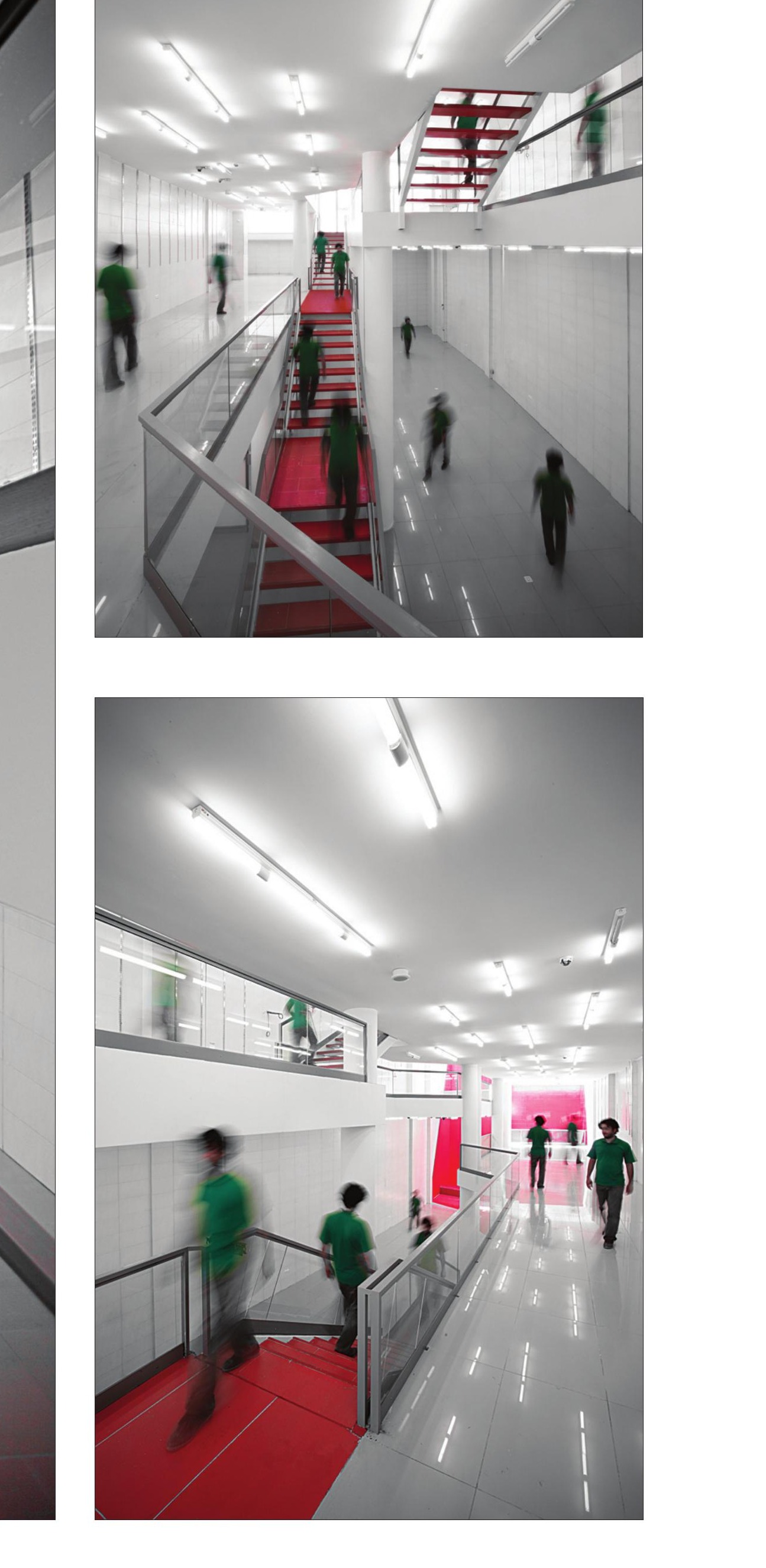 Mid-level walkway and red stair with people in green walking through the white shop interior