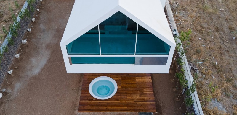 Top-down view of the rooftop pool inside the gable and the sunken jacuzzi on the patio below