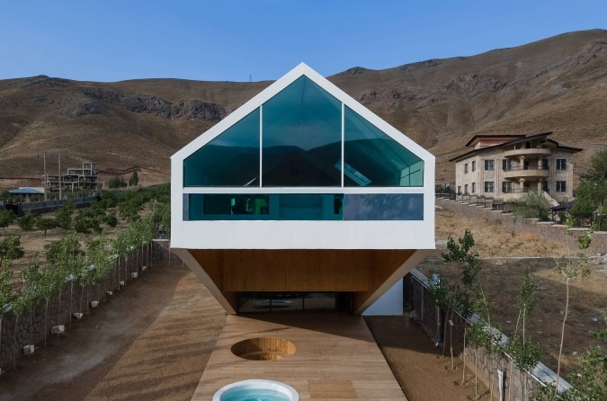Front view of the triangular glass gable above the cantilevered wood-clad terrace
