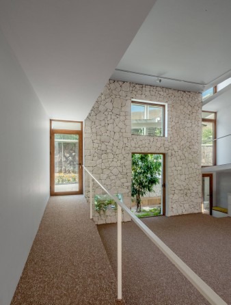 Stone-clad interior with the gentle ramp leading up between two walls