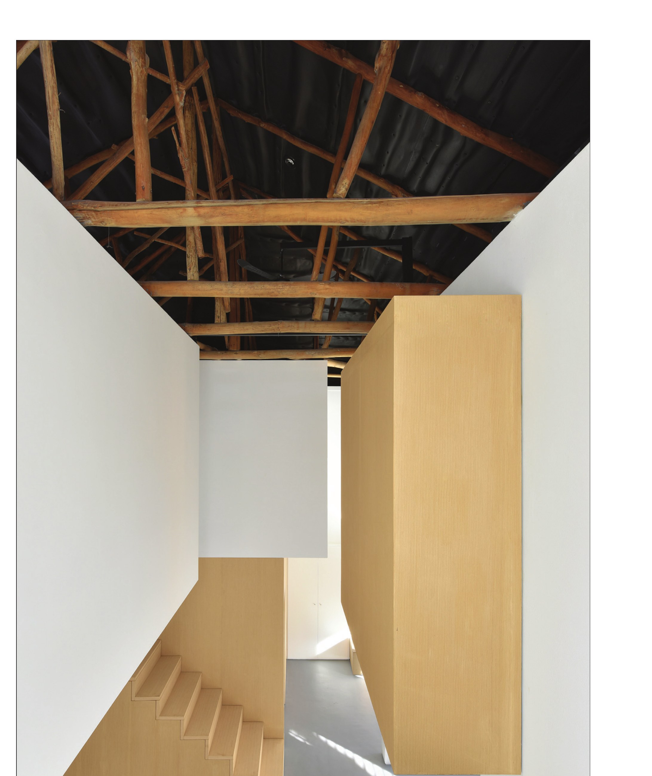 Stair void rising into the preserved wooden trusses