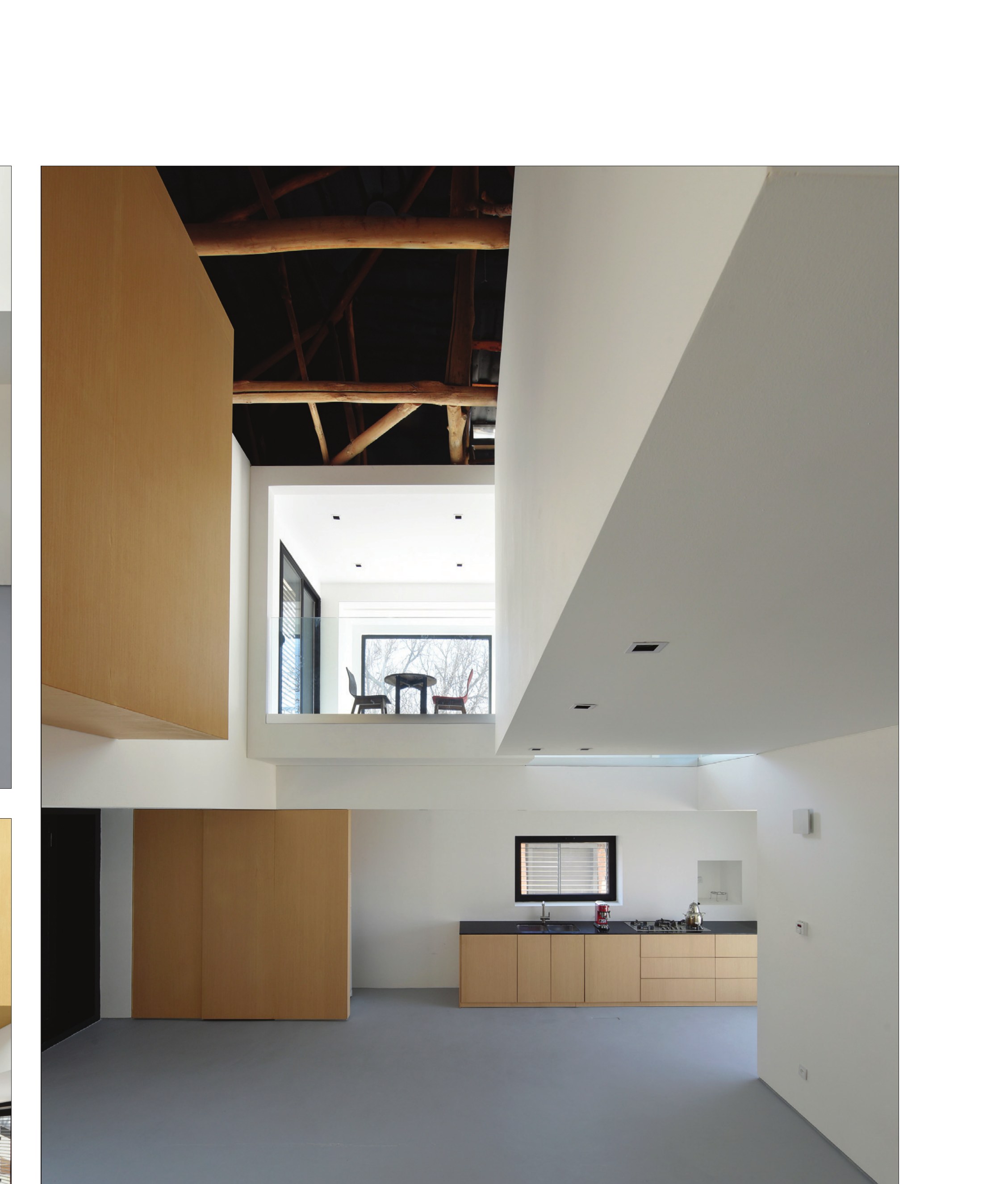 Double-height interior with cantilevered loft and exposed truss