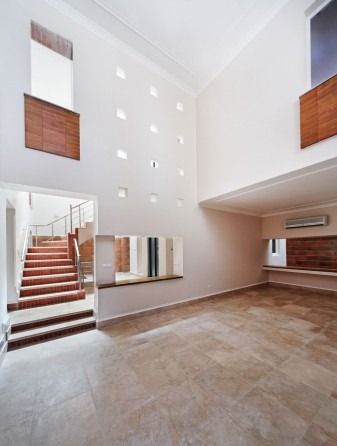 Triple-height interior hall with grid of small skylights