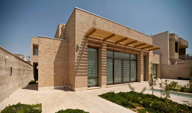 Front facade with wooden pergola entrance over the south courtyard