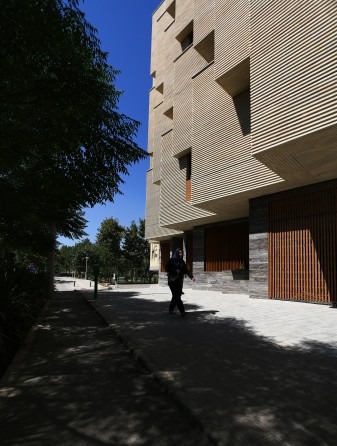 Khab-e-Aram facade detail at a terrace edge showing the polished concrete soffit and the wooden balcony rail