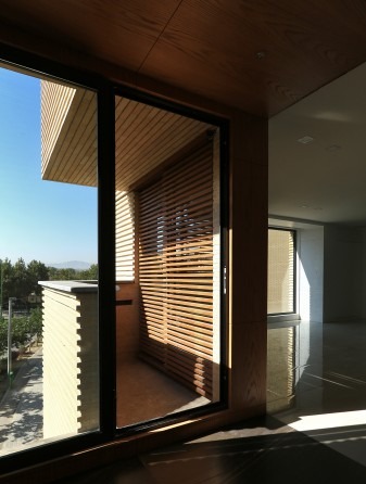 Khab-e-Aram interior of a living room with the south-facing window and a wood-framed balcony beyond