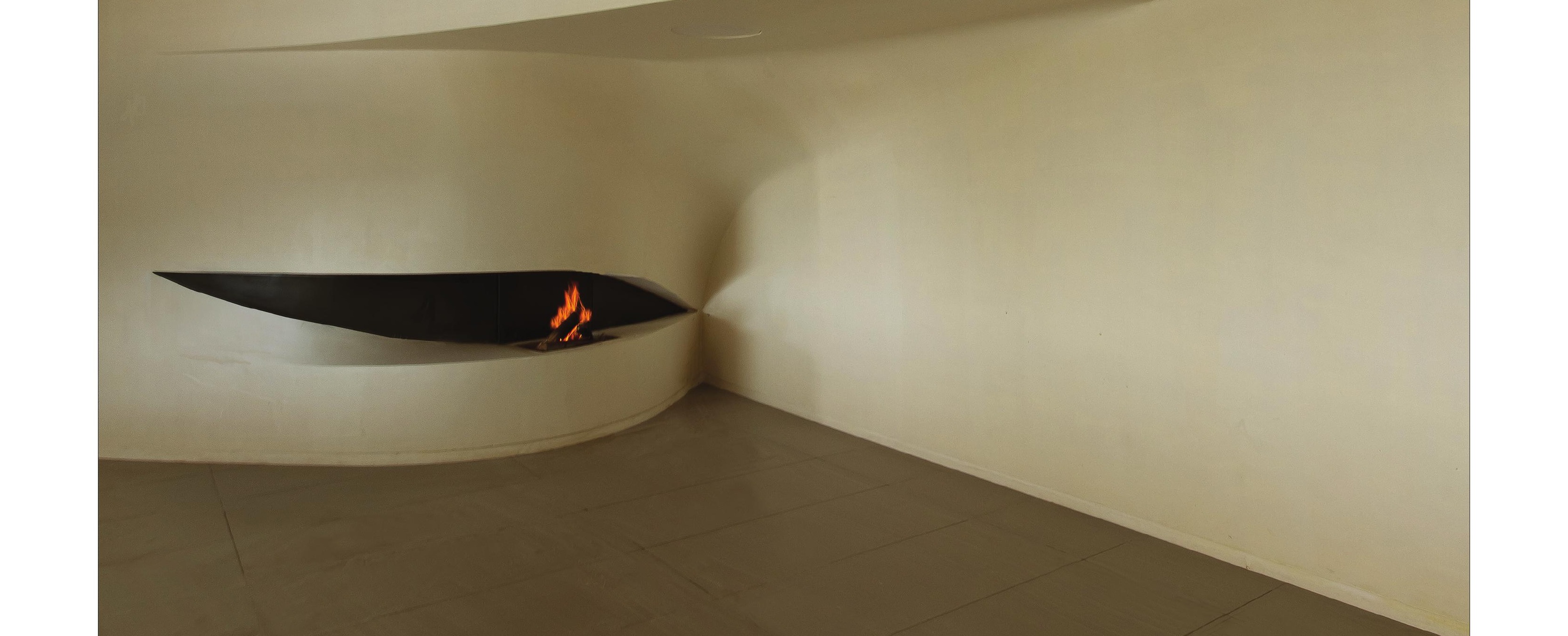 Living room with floating-flame fireplace embedded in the curved wall
