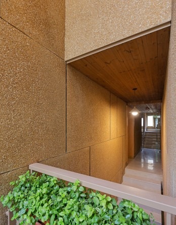 Malek Residential Building interior — a central reading nook with bookshelves and a small skylight