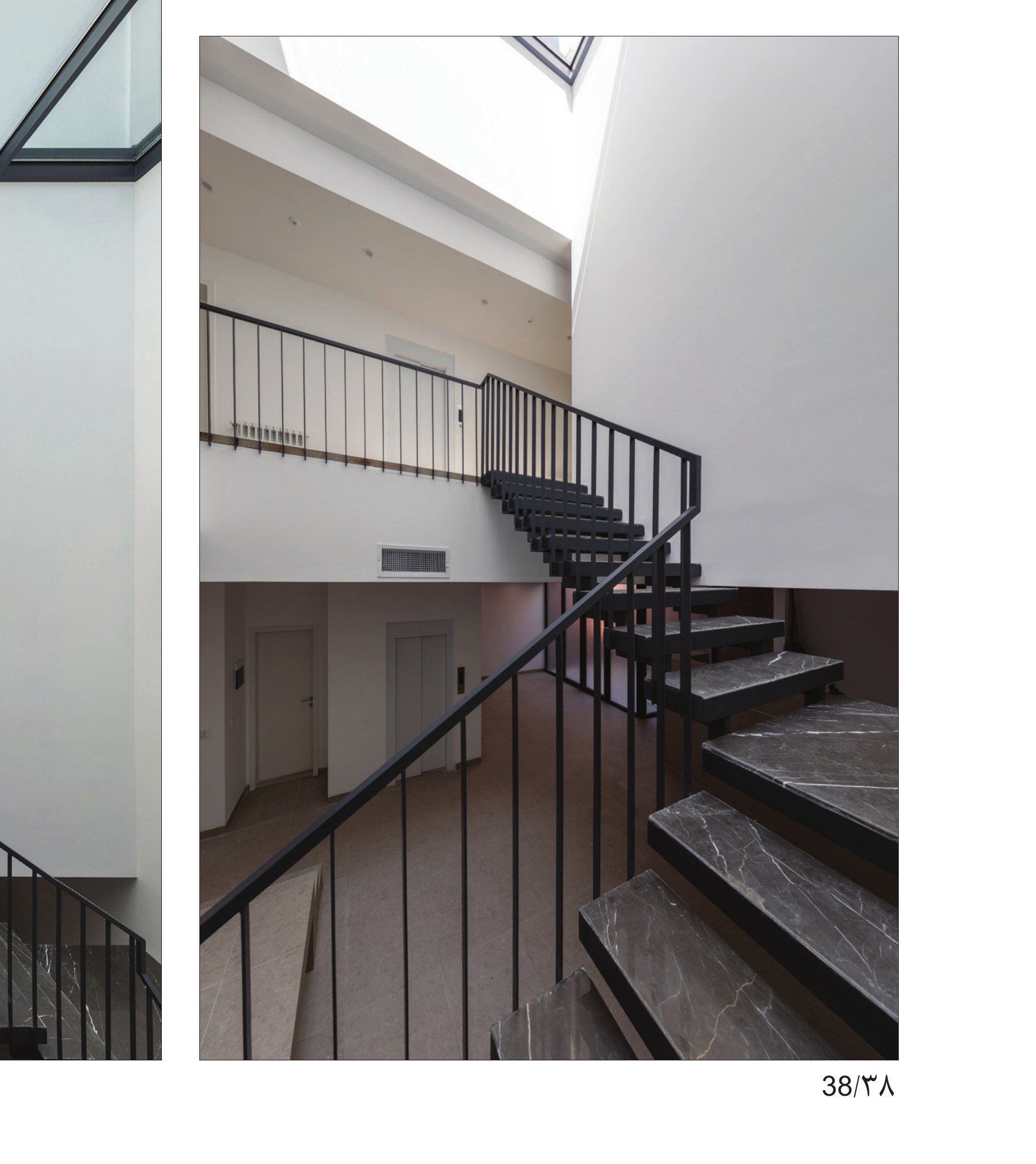 Stair void with overhead skylight and stone treads