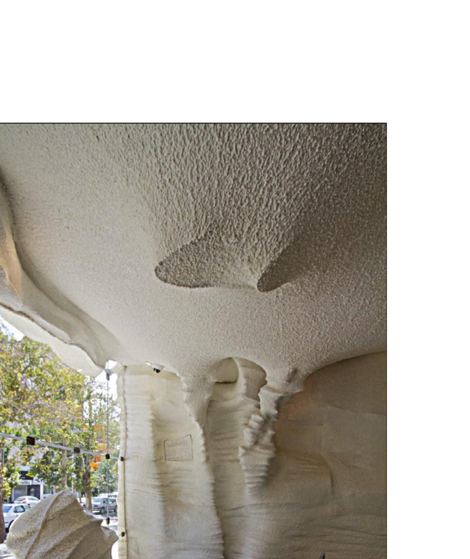 Interior salt-cavern soffit and column with sky visible through the facade opening