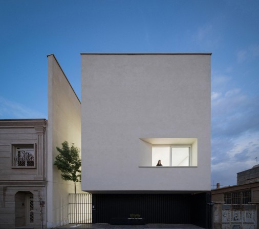 Street facade with a single high window over the entry