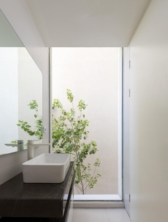 Bathroom with full-height window onto the eastern alley