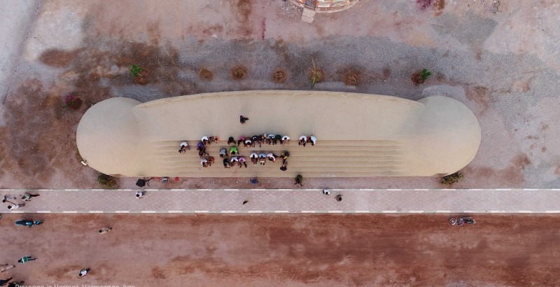 Rong Cultural Center — children playing in the shaded courtyard of the cultural centre between the domes