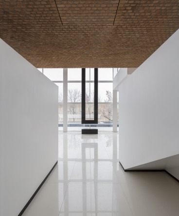 Safadasht Dual interior — a glass-walled celebration hall with a slim staircase to one side