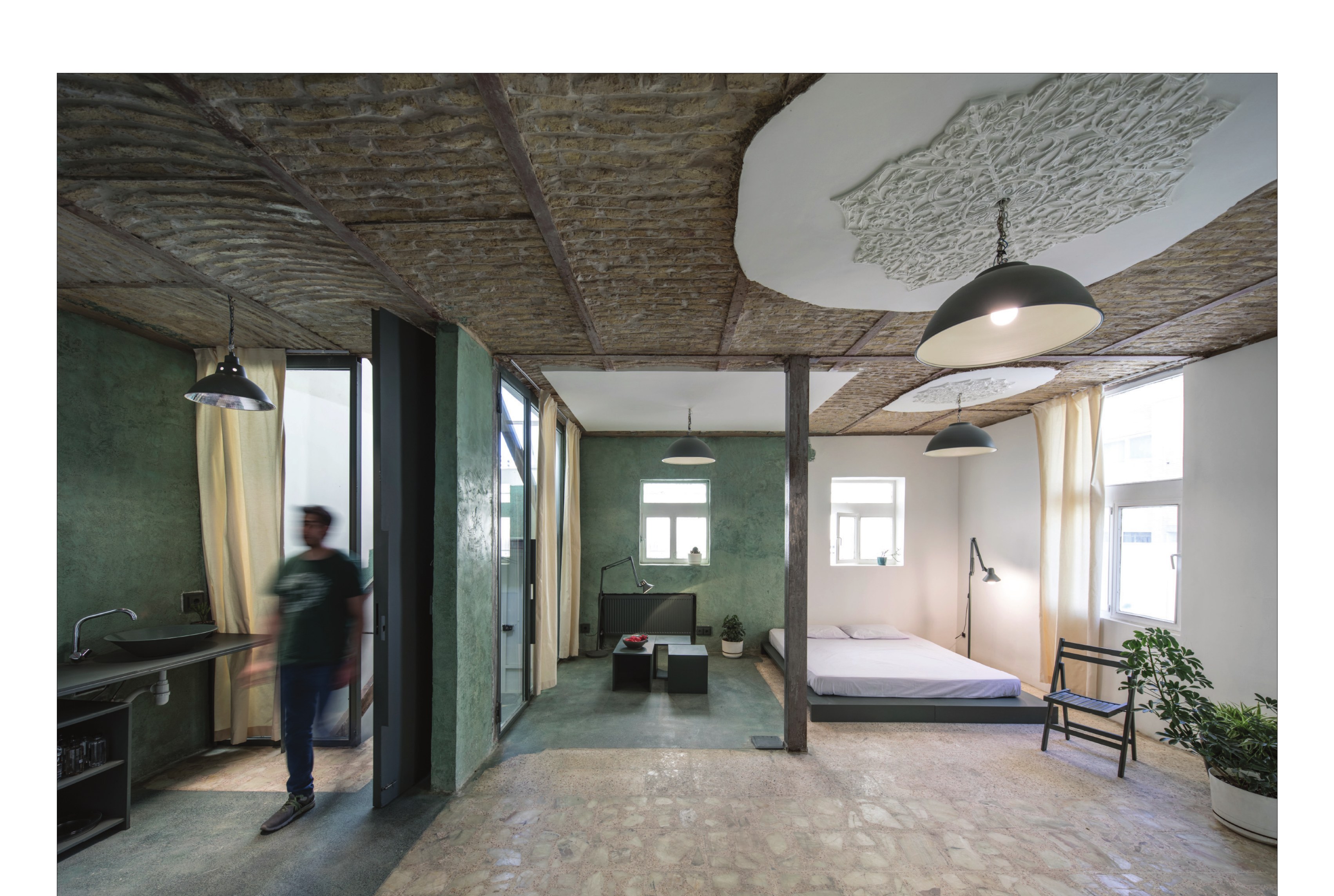 Long interior view across the green-walled main hall