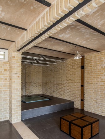 Interior of Shahrasb Villa with shallow brick vaults overhead and arched doorways