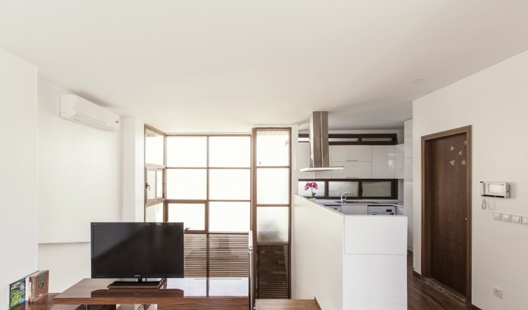 Small House — a planted half-landing with a sofa next to a tall window