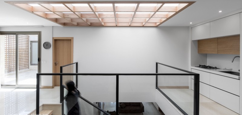 Top-lit central hall with wooden grid ceiling