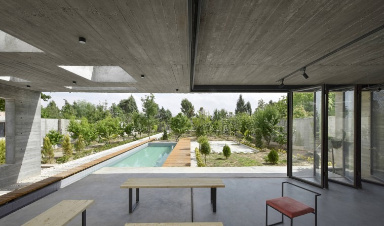Inside the main space with its retractable glass folded away: the project's principal interior can become an open loggia