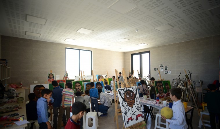 Brick-clad classroom volumes with mountain backdrop