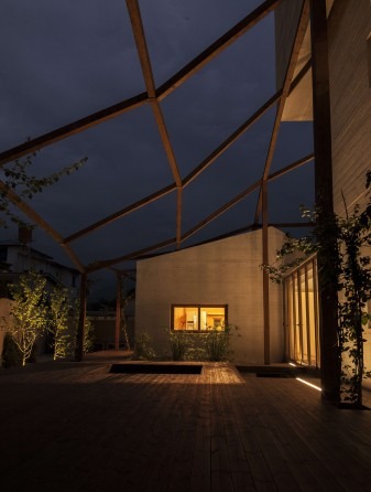 A bedroom pavilion at Vanoosh Villa — softly lit at dusk with a skylight strip running along the wall