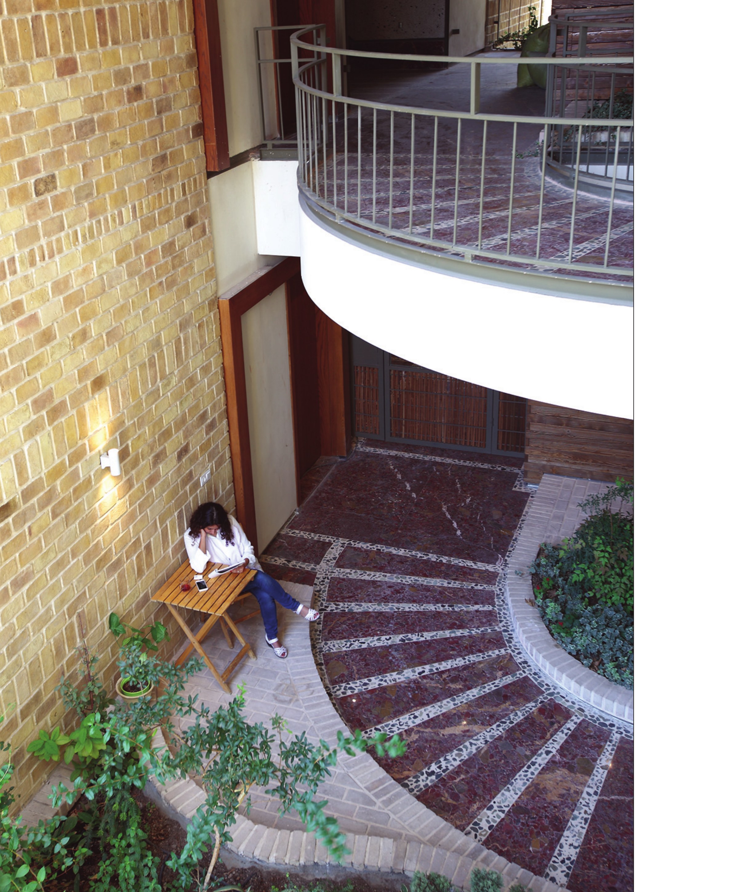 Spiral entry courtyard with brick walls and balconies